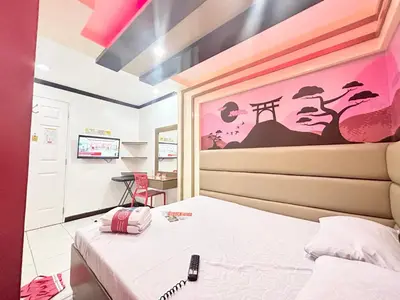 a bedroom with a bed and a painting on the wall at Hotel Sogo Molino in Cavite