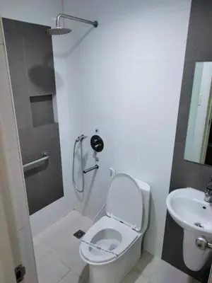 a bathroom with a toilet and a sink at Hotel Sogo Molino in Cavite