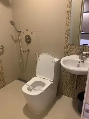 a bathroom with a toilet and a sink at Hotel Sogo San Pedro in San Pedro