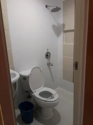 a bathroom with a toilet and a sink at Hotel Sogo San Pedro in San Pedro