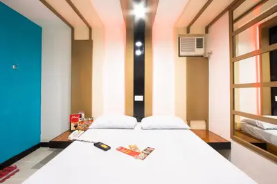a bedroom with a large white bed in a room at Hotel Sogo Santolan in Manila