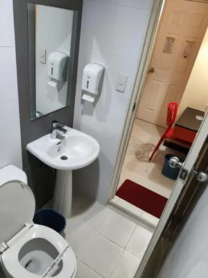 a small bathroom with a toilet and a sink at Hotel Sogo Recto in Manila
