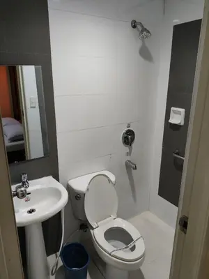 a small bathroom with a toilet and a sink at Hotel Sogo Recto in Manila