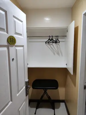 a room with a closet with a stool in it at Hotel Sogo Recto in Manila