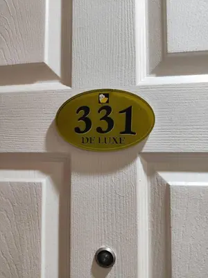 a yellow door sign on a white door at Hotel Sogo Recto in Manila