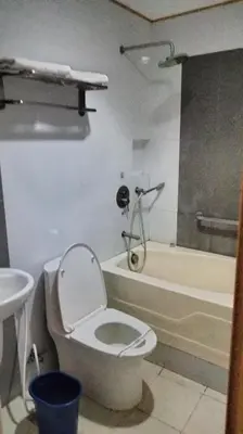 a bathroom with a toilet and a shower and a sink at Hotel Sogo Sta Rosa in Santa Rosa