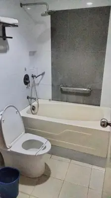 a bathroom with a toilet and a bath tub at Hotel Sogo Sta Rosa in Santa Rosa