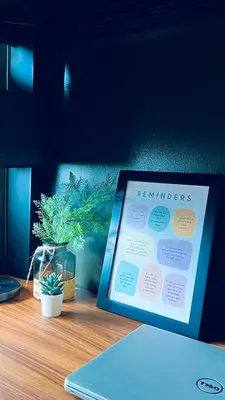 a table with a laptop and a sign on it at WinTer Home Stay at S Residences Near Mall of Asia in Manila