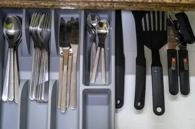 a group of utensils sitting on a shelf at 2BR Fully Air-Conditioned Staycation PLUS Free Parking in Manila