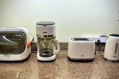 two toasters and a coffee maker on a counter at 2BR Fully Air-Conditioned Staycation PLUS Free Parking in Manila