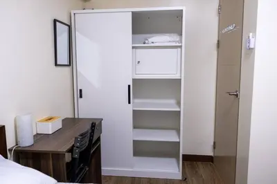 a bedroom with a desk and a closet at 2BR Fully Air-Conditioned Staycation PLUS Free Parking in Manila