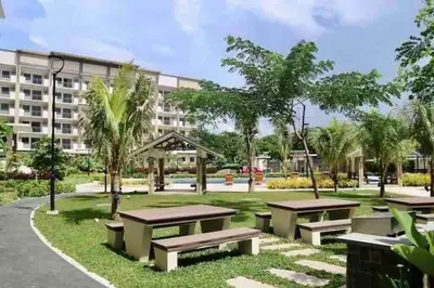 a park with picnic tables in front of a building at 2BR Fully Air-Conditioned Staycation PLUS Free Parking in Manila