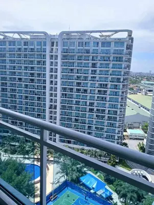a view from the balcony of a large building at Caroshiro Staycation Azure Uban Resort in Manila