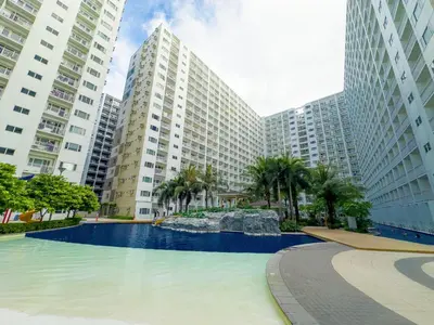 a swimming pool in front of some tall buildings at GemstoneBR in SMDC Shore Residences in Manila