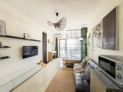 a living room with a couch and a tv at GemstoneBR in SMDC Shore Residences in Manila