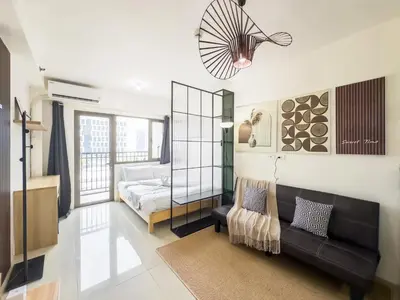 a living room with a couch and a bed at GemstoneBR in SMDC Shore Residences in Manila