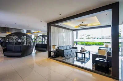 a living room with a couch and a chair at GemstoneBR in SMDC Shore Residences in Manila