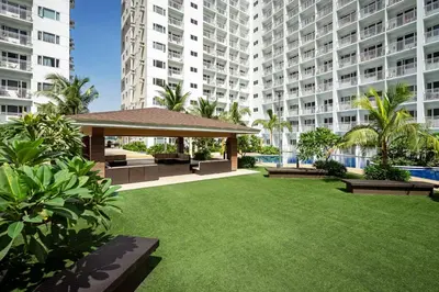 a garden with a gazebo in front of a building at GemstoneBR in SMDC Shore Residences in Manila