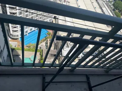 a balcony with a view of a pool and buildings at SOHO Central EDSA Shaw Condo Pool front with SMART TV in Manila
