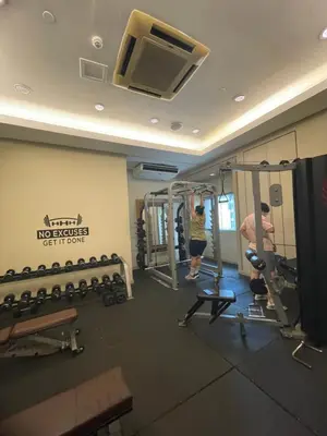 a room with a gym with two people in it at SOHO Central EDSA Shaw Condo Pool front with SMART TV in Manila