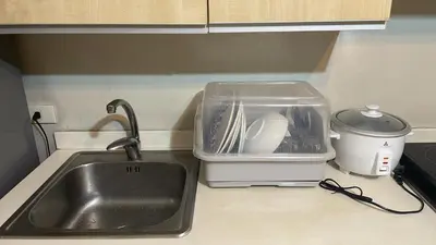 a kitchen counter top with a sink and a sink at SOHO Central EDSA Shaw Condo Pool front with SMART TV in Manila