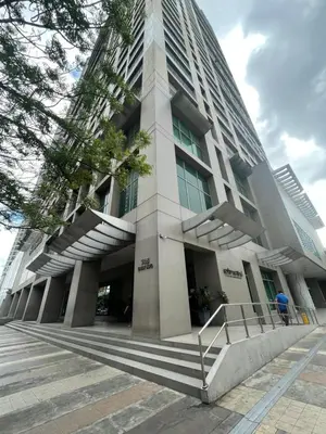 a large building with stairs in front of it at SOHO Central EDSA Shaw Condo Pool front with SMART TV in Manila