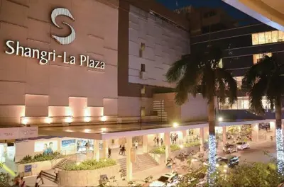 a shopping mall with a sign on the side of it at SOHO Condotel EDSA Shaw near SM Megamall FREE Pool Access in Manila