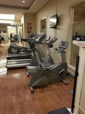 a gym with rows of exercise bikes and a sign at SOHO Condotel EDSA Shaw near SM Megamall FREE Pool Access in Manila