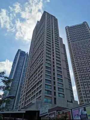 a tall building in a city with two tall buildings at SOHO Condotel EDSA Shaw near SM Megamall FREE Pool Access in Manila