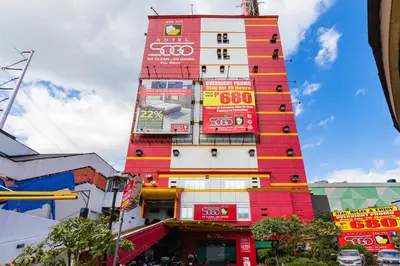 a tall building with colorful signs on it at Hotel Sogo Santa Mesa in Manila