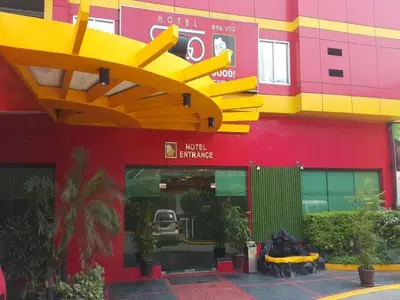 a building with a large yellow and red building at Hotel Sogo Santa Mesa in Manila