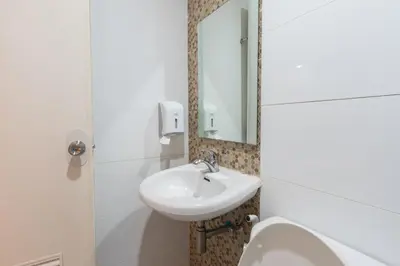 a bathroom with a sink and a mirror at Hotel Sogo Santa Mesa in Manila