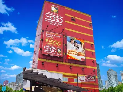 a tall building with signs on the side of it at Hotel Sogo Santa Mesa in Manila