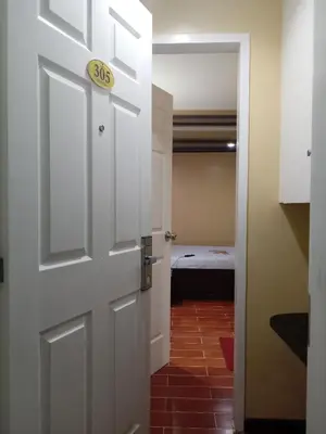 a door leading into a room with a bedroom at Hotel Sogo Edsa Taft in Manila