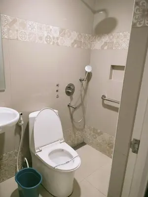 a bathroom with a toilet and a sink at Hotel Sogo Edsa Taft in Manila