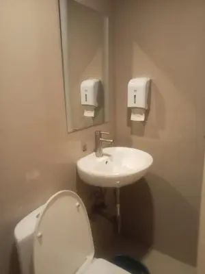 a bathroom with a toilet and a sink at Hotel Sogo Pasay Wood Street in Manila