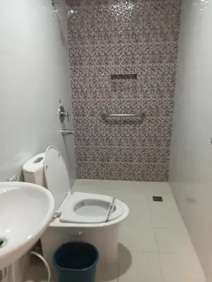 a bathroom with a toilet and a sink at Hotel Sogo Pasay Wood Street in Manila