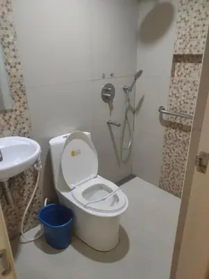 a bathroom with a toilet and a sink at Hotel Sogo Macapagal in Manila