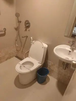 a bathroom with a toilet and a sink at Hotel Sogo Macapagal in Manila