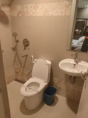 a bathroom with a toilet and a sink at Hotel Sogo Macapagal in Manila
