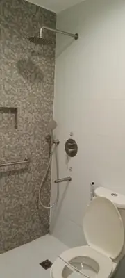 a bathroom with a toilet and a shower at Hotel Sogo Buendia in Manila