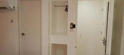 a white cabinet with a door in a room at Hotel Sogo Buendia in Manila