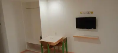 a room with a table and a television on a wall at Hotel Sogo Buendia in Manila