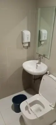 a bathroom with a toilet and a sink at Hotel Sogo Buendia in Manila