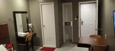a room with a door and a table and a mirror at Hotel Sogo Buendia in Manila