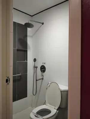 a bathroom with a toilet and a shower at Hotel Sogo Roxas Blvd in Manila