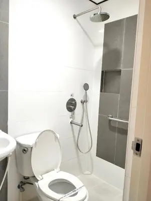 a bathroom with a toilet and a shower at Hotel Sogo Roxas Blvd in Manila