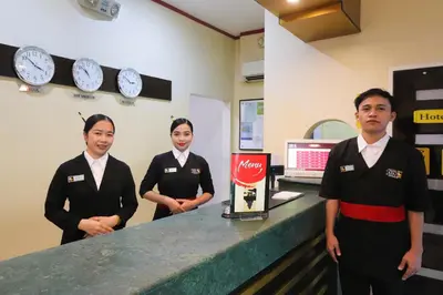 a group of three people standing at a counter at Hotel Sogo Yabut in Manila