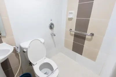 a bathroom with a toilet and a sink at Hotel Sogo Yabut in Manila