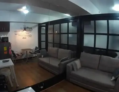 a living room with couches and a table at Rsquared Condo in Manila